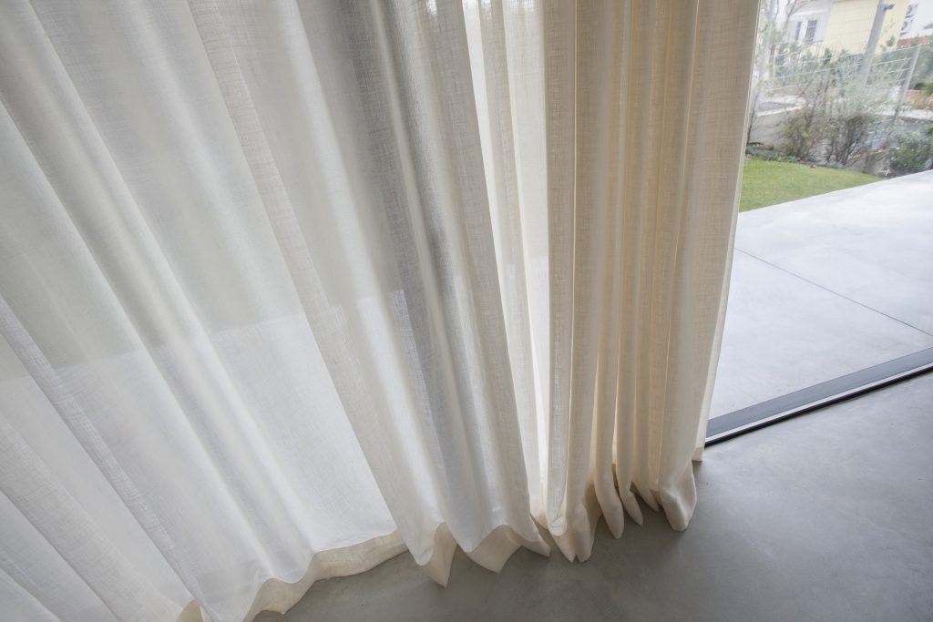 Close-up of white traditional drapery with deep folds and rich texture